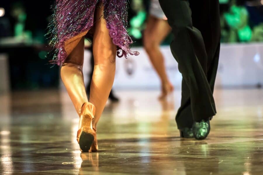 Close-up of dancing feet in motion, a glamorous couple performing on Strictly Come Dancing.