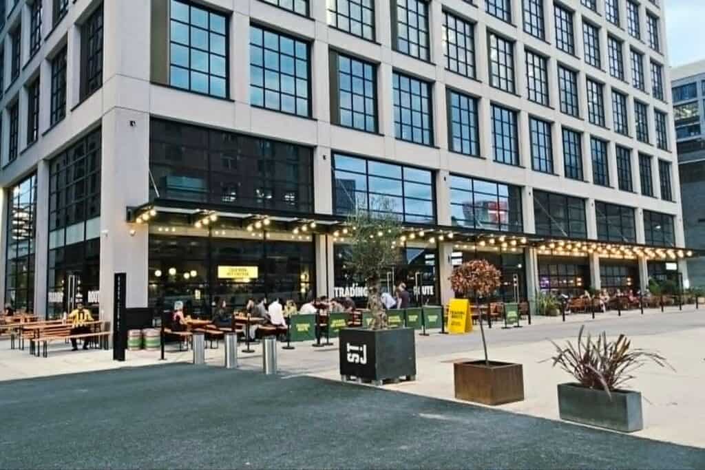 Outdoor seating and summer dining in the St John’s area of Manchester city centre, with bars, restaurants and modern buildings.