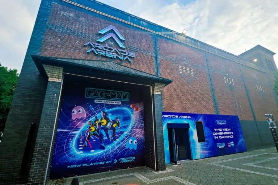 Exterior view of Arcade Arena in Manchester, with vibrant signage and accessible entrance.