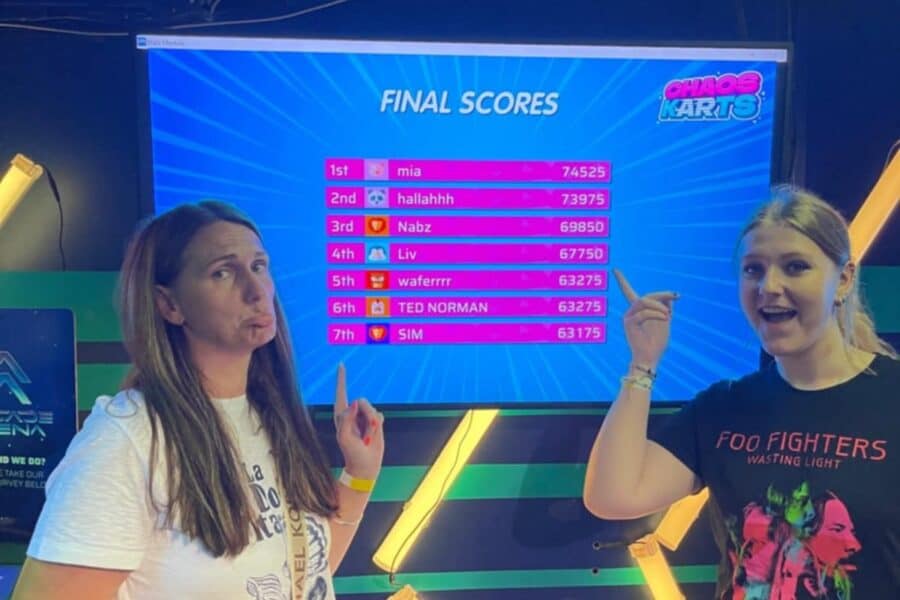 Blue TV screen displaying the overall leaderboard at Chaos Karts Manchester with player rankings.